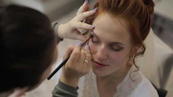 Wedding Makeup Artist Making a Make Up for Bride in Veil