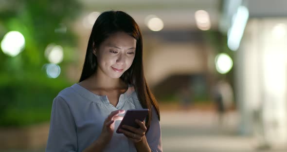 Woman use of mobile phone at night