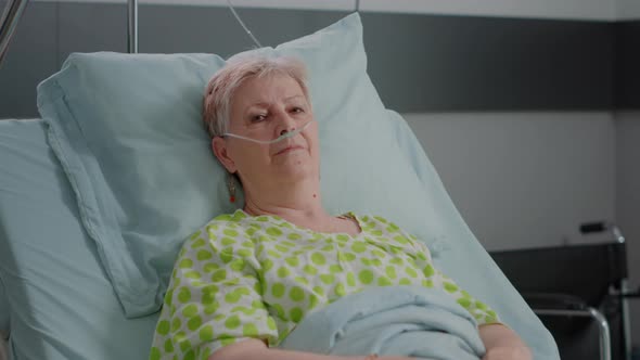 Portrait of Senior Woman Laying in Hospital Ward Bed