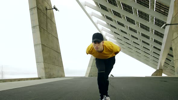 Epic Portrait and close upt of a Young Attractive Trendy Man skateboarding fast under a solar panel