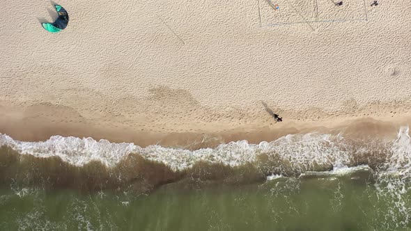 AERIAL: Top Shot of Couple Walking on Sandy Beach Holding Hand near Baltic Sea