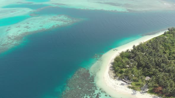 Aerial: flying over tropical island white beach caribbean sea turquoise water co