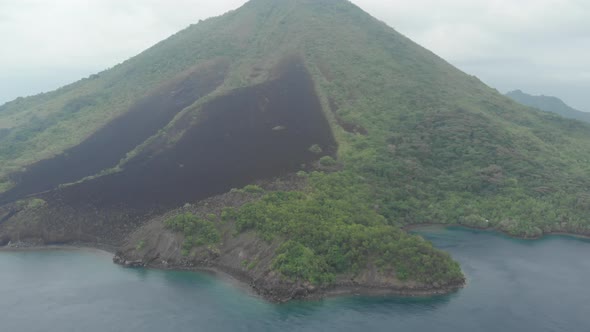 Aerial: flying over Banda Islands active volcano Gunung Api lava flows Indonesia