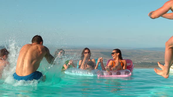 Women on mattress and men jumping in the pool, Ultra Slow Motion