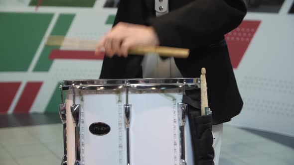 Musician in Black Suit Plays Drum Supporting Hockey Team