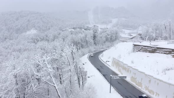 Aerial View Flying Winter Ski Resort Building with Highway Traffic Funicular Picturesque Scenery