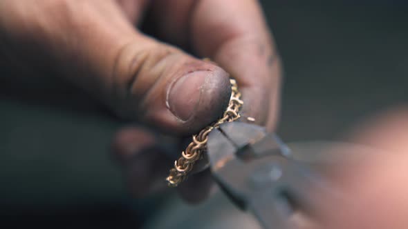 Jeweler Removes Leftovers From Chain with Pliers Closeup