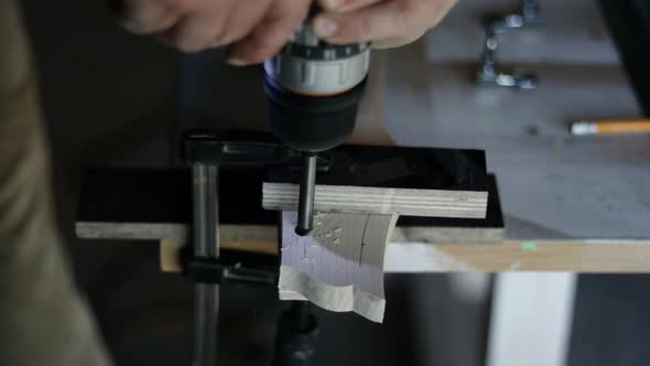 Craftsman hands working on guitar making