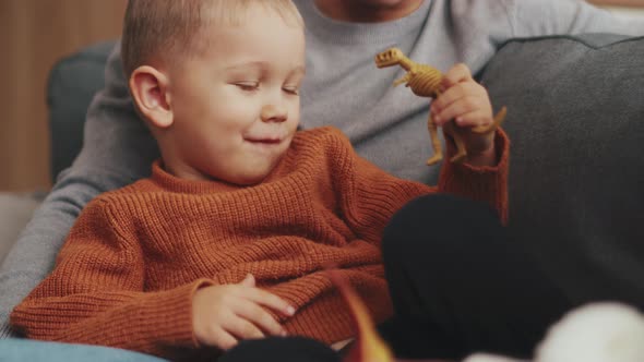 Cheerful little child playing with toys