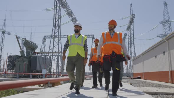 Man Showing Power Station To Inspectors