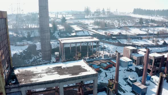 Aerial - rundown factory building, Vlahita, Romania, lowering wide shot