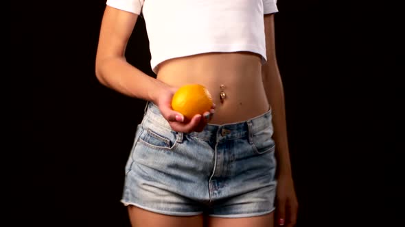 Slim Woman with Apple in Her Hand, Spinning, on Black Background