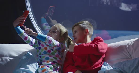 Boy and Girl Taking Selfie in a Spaceship