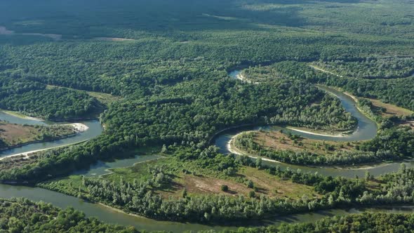 Aerial View of Winding River in Forest