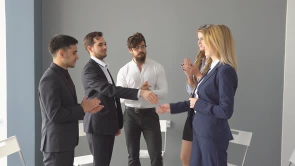 Group of Young Businessman on Business Meeting. Successful Negotiations a Completed with a Handshake