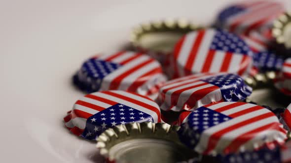 Rotating shot of bottle caps with the American flag printed on them 