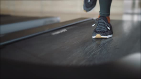 Young Fit Woman Running on Treadmill in Gym. Cardio Training Weight Loss Concept. Slowmotion Footage