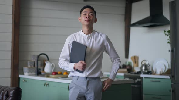 Portrait of Confident Successful Man Posing with Tablet in Kitchen