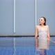 Young asian woman enjoy around outdoor swimming pool for leisure - VideoHive Item for Sale