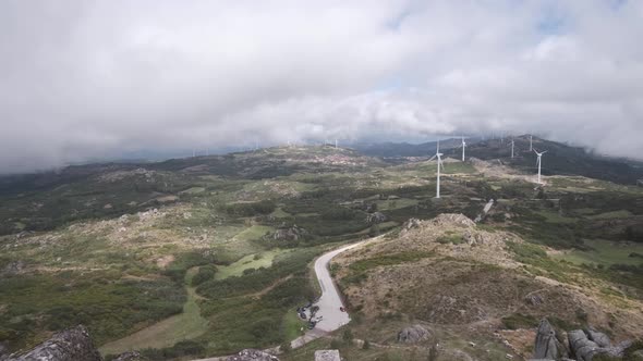 Eolic wind turbines seen from Caramulinho viewpoint on cloudy day. Caramulo in Portugal. Panning