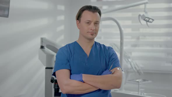 Young Doctor Standing In Dental Office