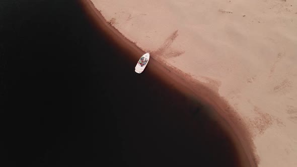 Scenic Aerial Top Down Shot Boat Parked at Beach During Sunset