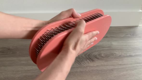 Women Hands Opening Yoga Board with Nails at Home