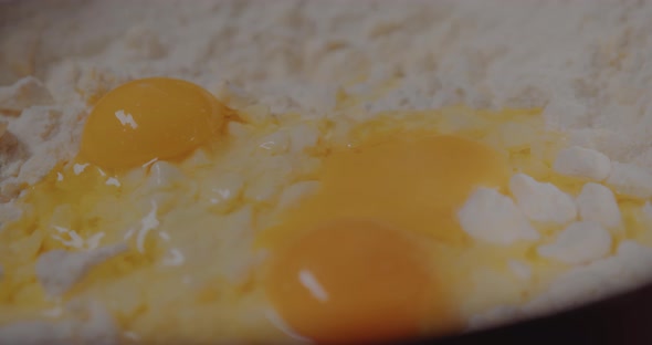 Female Hand Breaks Fresh Chicken Egg Into Bowl