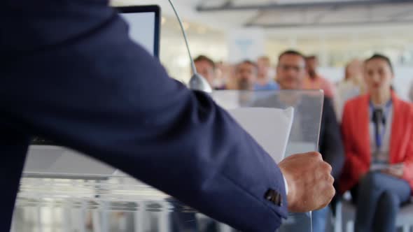 Male speaker addressing audience at a business conference