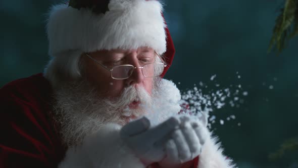 Santa Claus blowing snow from hands in slow motion, Phantom Flex 4K alt