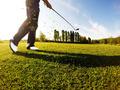 Golfer performs a golf shot from the fairway. - PhotoDune Item for Sale