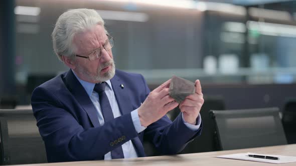 Old Businessman with Laptop Checking Empty Wallet