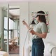 Young woman using virtual reality goggles at home - VideoHive Item for Sale