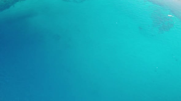 Aerial Top View of Blue Transparent Sea with Boats on the Rocky Coast of Croatia