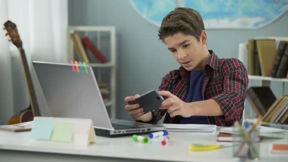 Kid Enthusiastically Playing Games on Mobile Phone