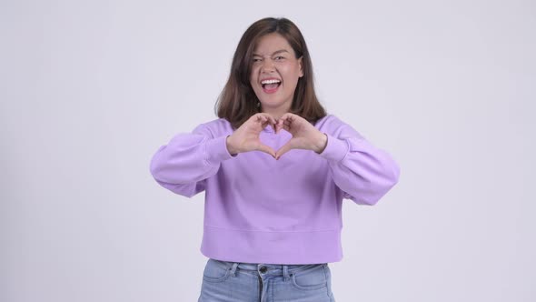 Young Happy Asian Woman with Hand Heart Gesture