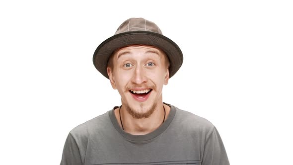 Young Handsome Man in Hat Smiling Laughing Over White Background