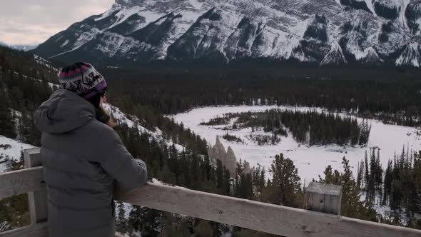 Hiker Girl Takes In the Amazing Scenic View at Mount Rundle in Banff, Tilt Up. Young Millenial in Wa