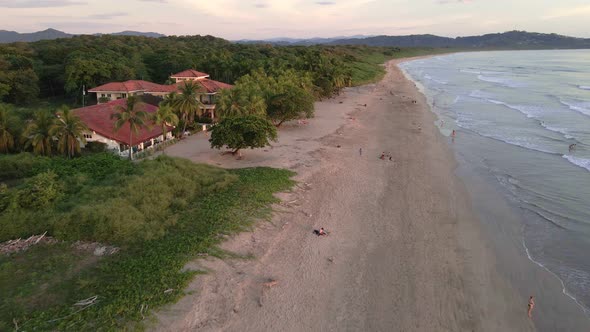 Fast fly-over at Playa Grande near Tamarindo, Costa Rica during warm and vibrant sunset. Almost empt