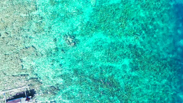 Tropical flying travel shot of a white paradise beach and turquoise sea background in high resolutio