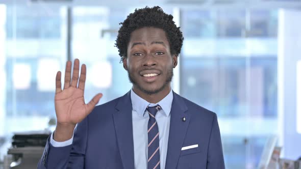 African American Businessman Waving and Smiling at Camera