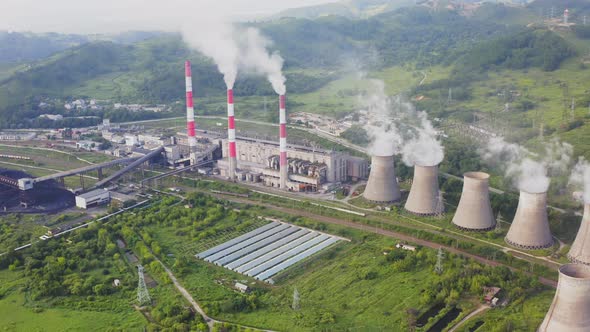 Aerial View of the Pipes of a Coal Power Plant and Cooling Tower