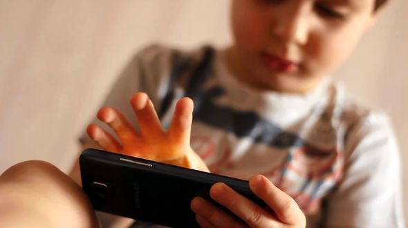 Portrait of A Child Playing with A Smartphone