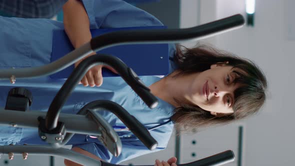 Vertical Video Portrait of Female Nurse Standing in Medical Cabinet