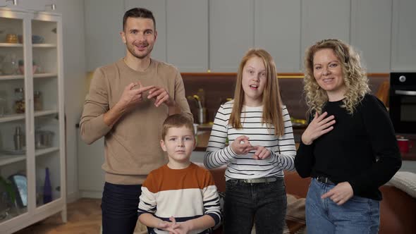 Joyful Deaf Family Talking with Gestures on Camera