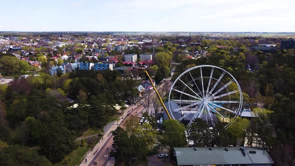 White Ferris wheel under construction with cityscape of Palanga, aerial view