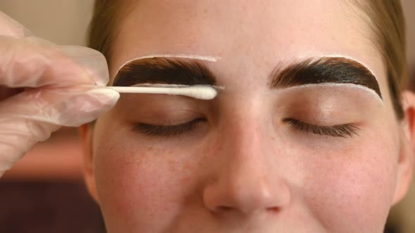 The Master Paints the Eyebrows of a Woman