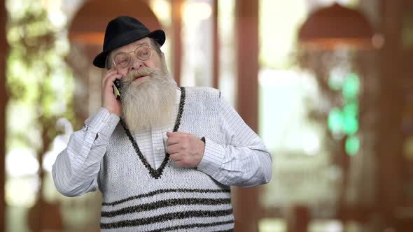 Old Longbearded Retired Grandpa Talking on Phone