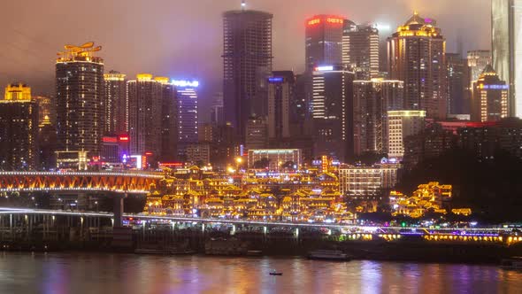 Chongqing/CHINA - JULY 28 2019: Chongqing Hongyadong Night Cityscape China Timelapse Pan Up