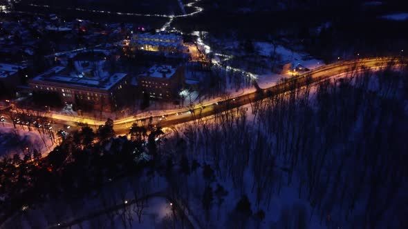 Cars driving illuminated street in night city